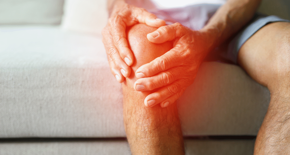 Holding knee in pain