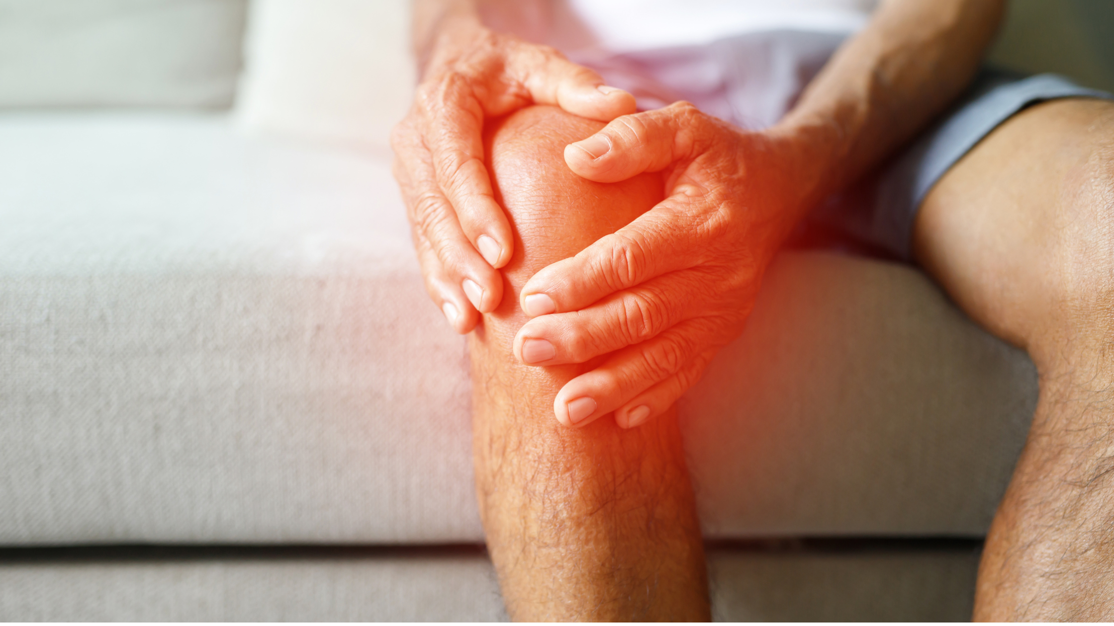 Holding knee in pain