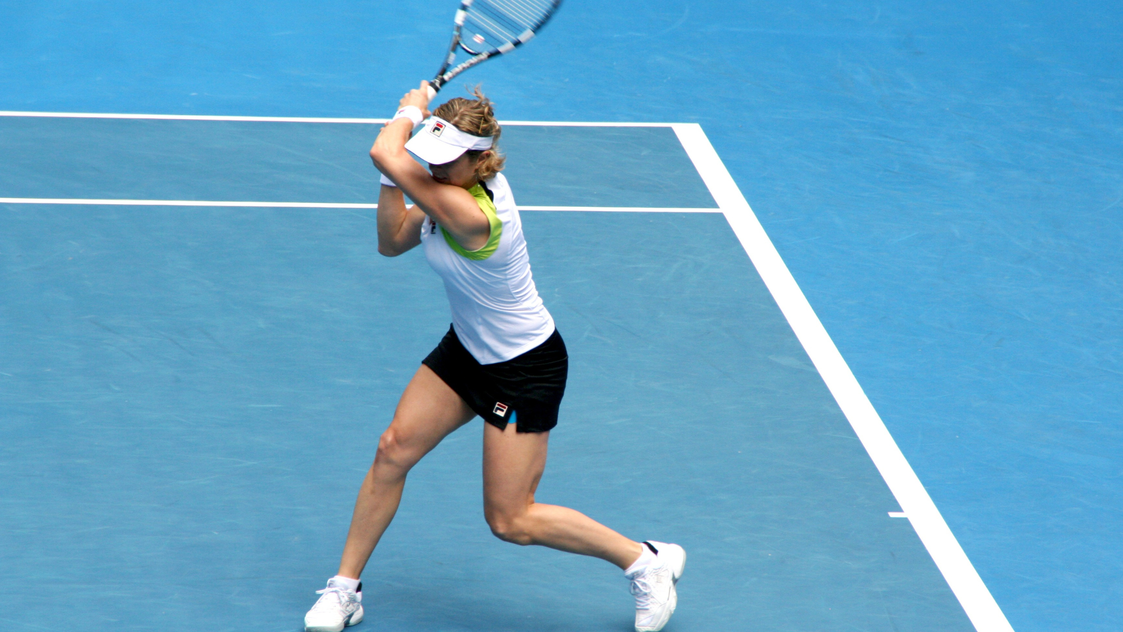 Tennis player swinging racquet