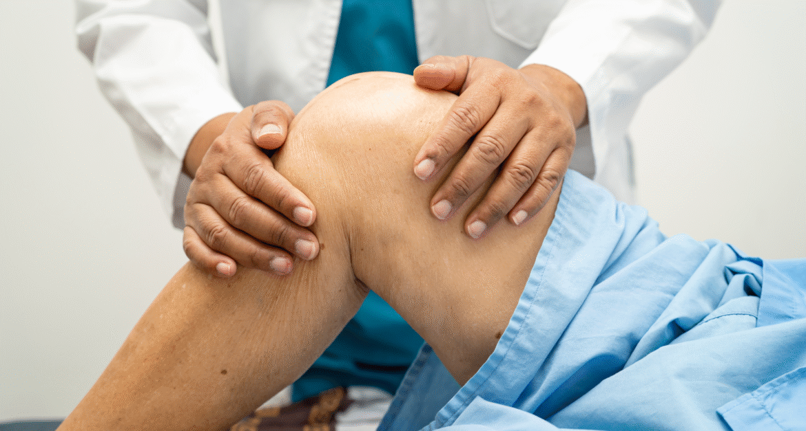 Doctor examining patients knee