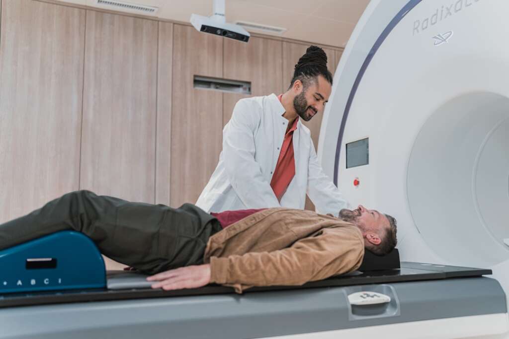 Doctor positioning patient for MRI scan in modern medical imaging facility
