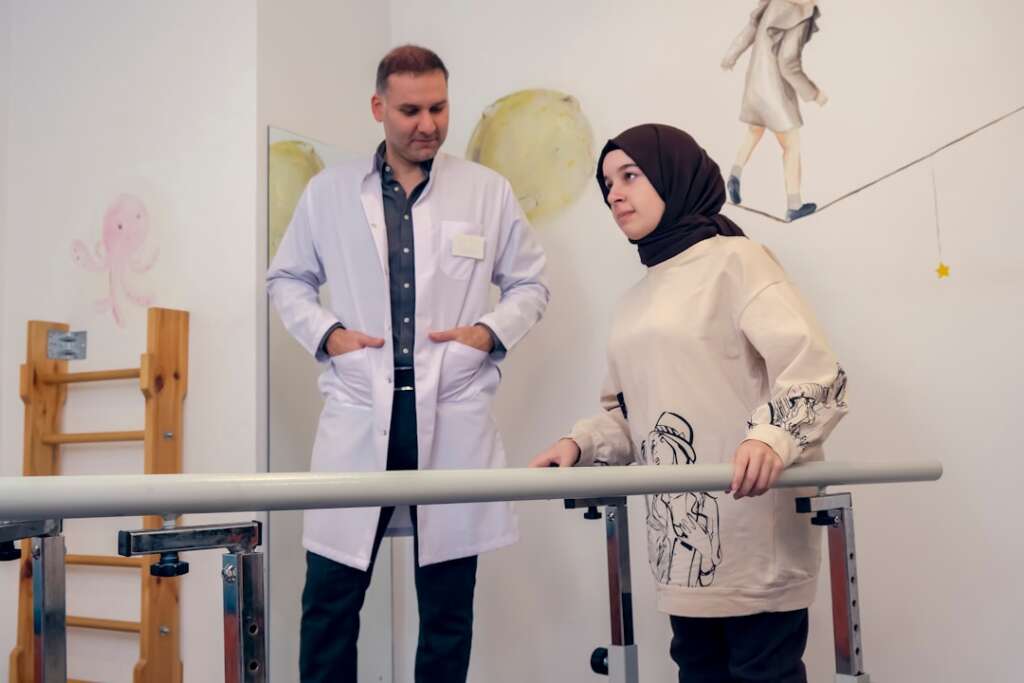 Patient working with doctor during orthopedic rehabilitation recovery