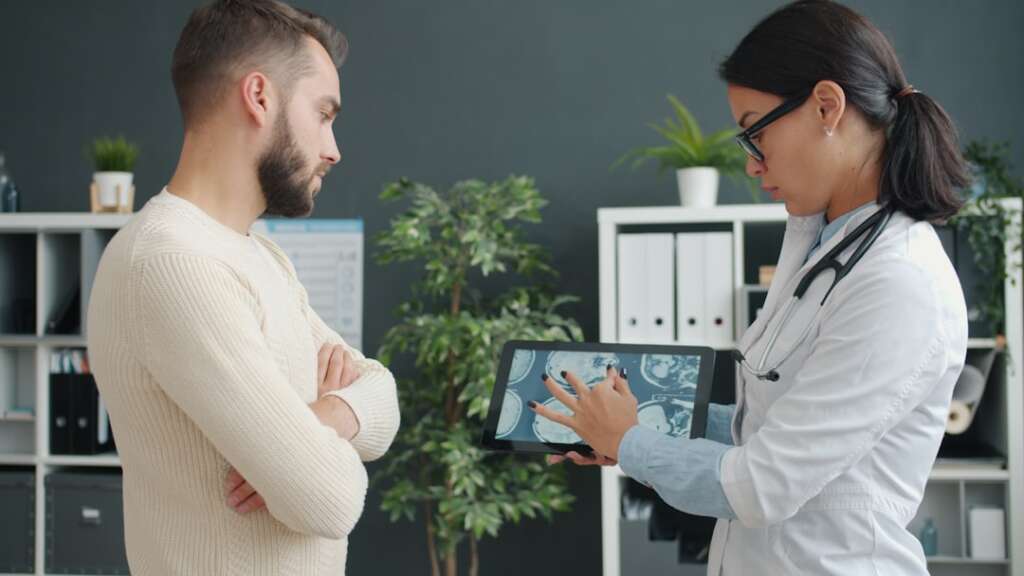 Doctor discussing MRI results and surgical options with spine patient
