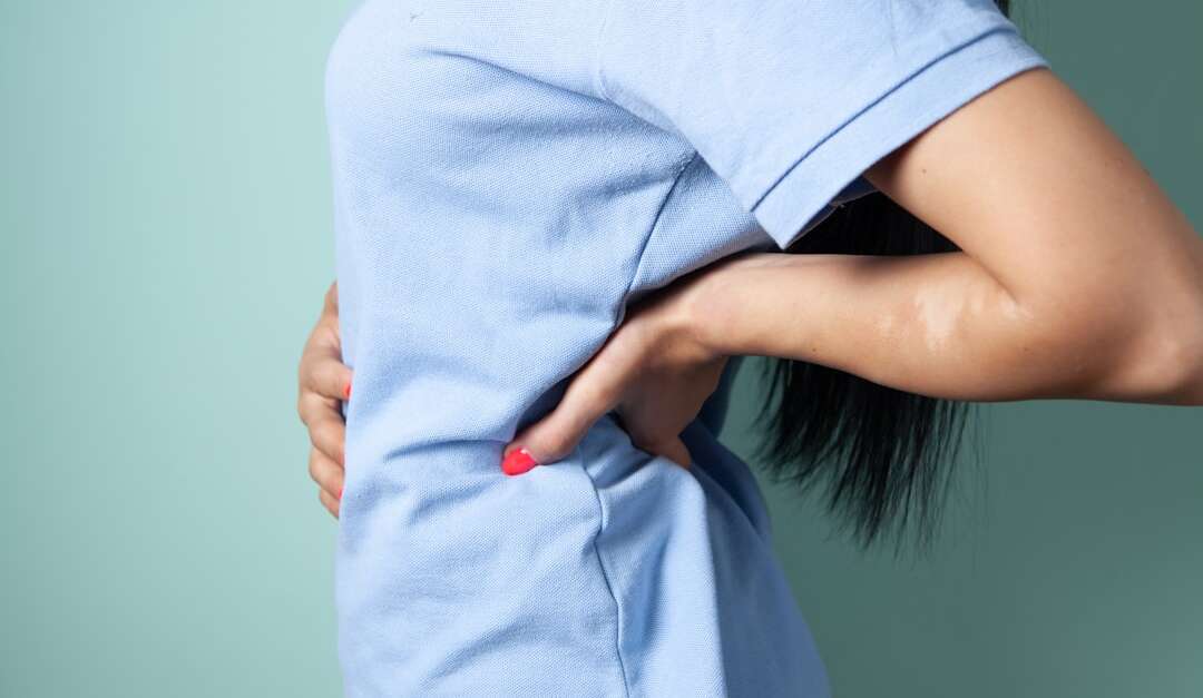 Working healthcare professional experiencing back pain, representing Forest Park residents seeking back pain treatment. Photo by Towfiqu barbhuiya on Unsplash