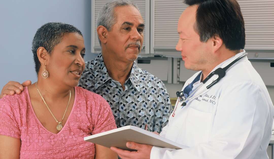 Doctor consulting with patients about medical treatment options in a healthcare setting