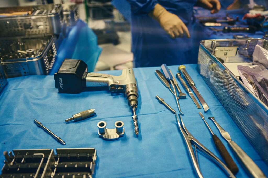 Orthopedic surgical tools laid out on a sterile drape in an operating room