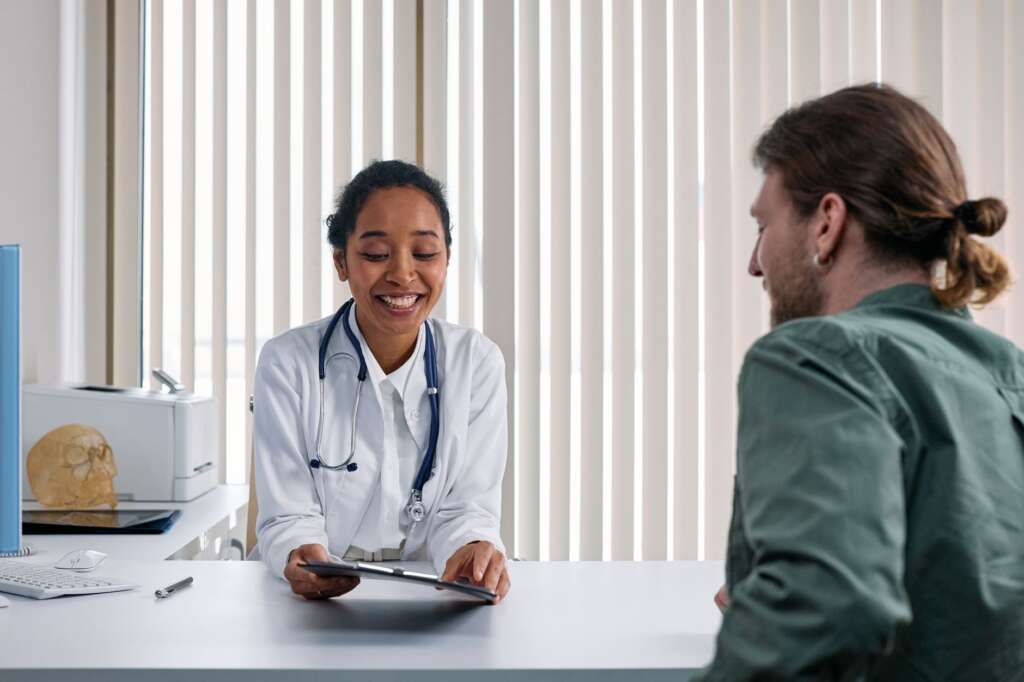 Doctor and patient engaged in a positive consultation discussing back pain treatment options