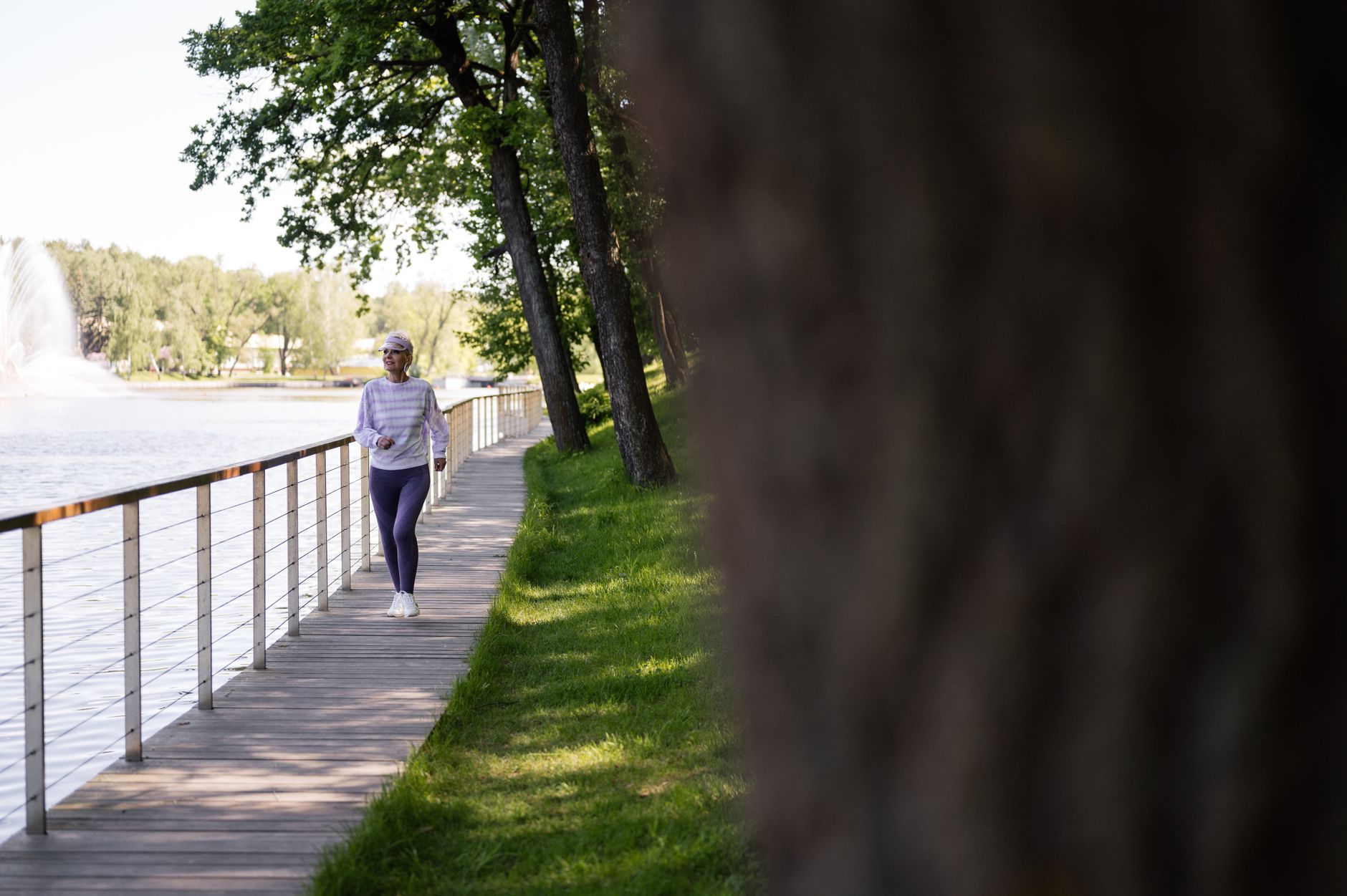 Senior woman walking comfortably outdoors after hip pain treatment — photo by Pexels