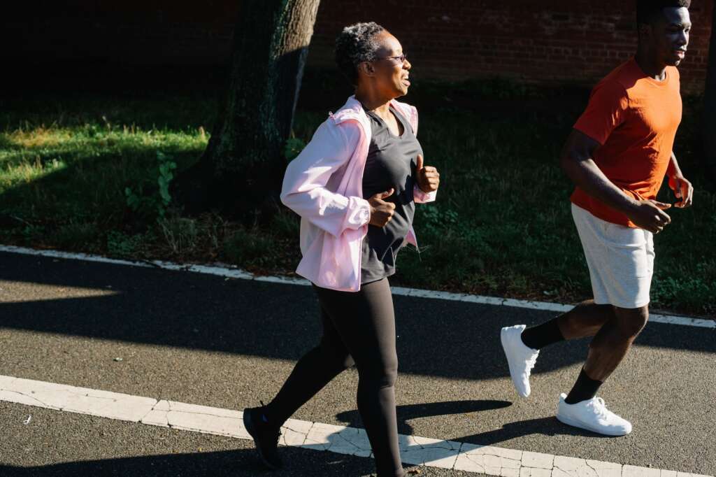 Active adults jogging outdoors on a sunny day representing the active community in Macon Georgia