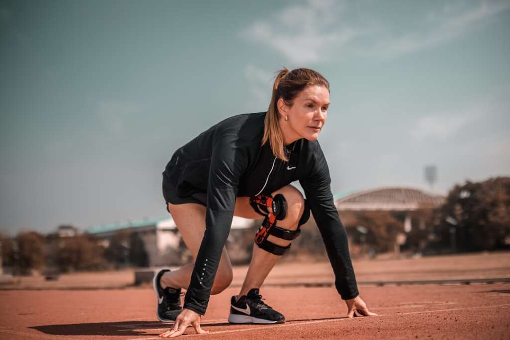 photo-1644492097455-d5f39f458fcd-4jpg - Barbour Orthopaedics & Spine Athlete wearing a knee brace preparing to return to sport after orthopedic treatment