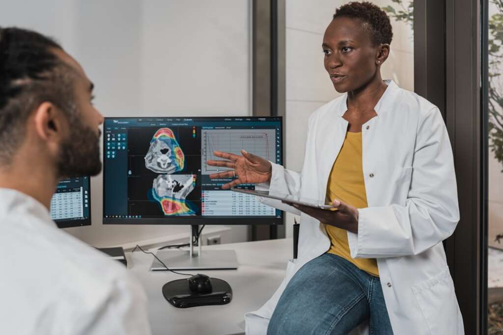 photo-1666214280557-f1b5022eb634-3jpg - Barbour Orthopaedics & Spine Physician reviewing MRI imaging results with a colleague to evaluate an orthopedic condition