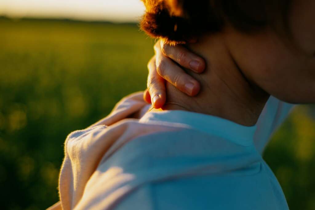 photo-1718964382697-897985745c3cjpg - Barbour Orthopaedics & Spine Woman holding her neck in pain outdoors - when to see a neck doctor